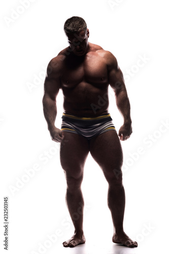 large powerful man showing his muscles in the Studio without a shirt on white background