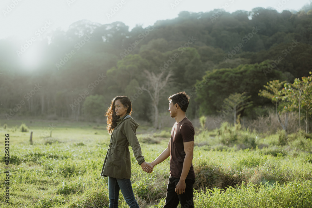 happy young asian couple in countryside enjoying nature happy young asian couple in countryside enjoying nature