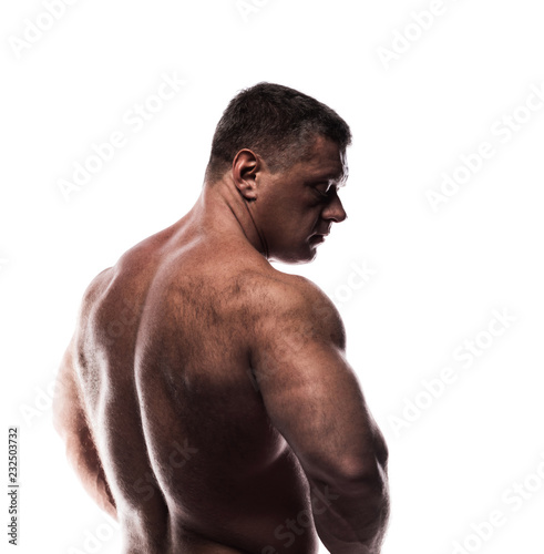 large powerful man shows his back in the Studio without a shirt on white background, sitting on his knee