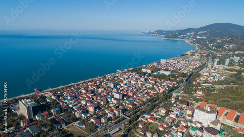 Adler microdistrict, Sochi, Russia. Aerial view of a coastal town in mountains