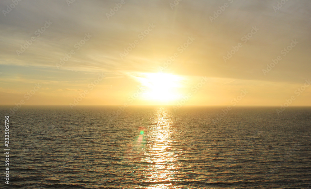 Sky Nature View of Sunset Over Calm Sea Water with Light Orange Cloudscape. Beautiful Sky Background at Sunset or Sunrise, Dusk or Dawn Panoramic Skyline View with Still Water on Summer Season Day