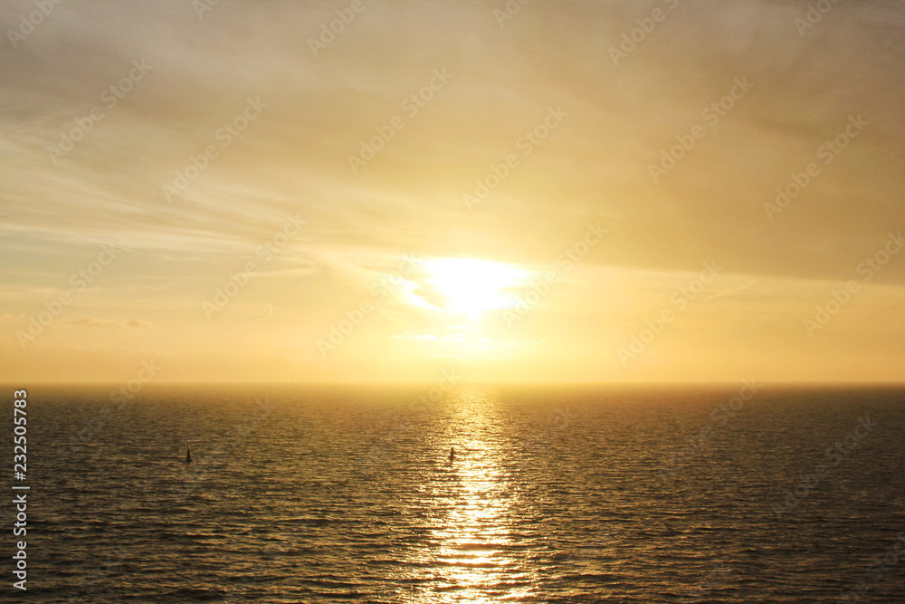 Sky Nature View of Sunset Over Calm Sea Water with Light Orange Cloudscape. Beautiful Sky Background at Sunset or Sunrise, Dusk or Dawn Panoramic Skyline View with Still Water on Summer Season Day