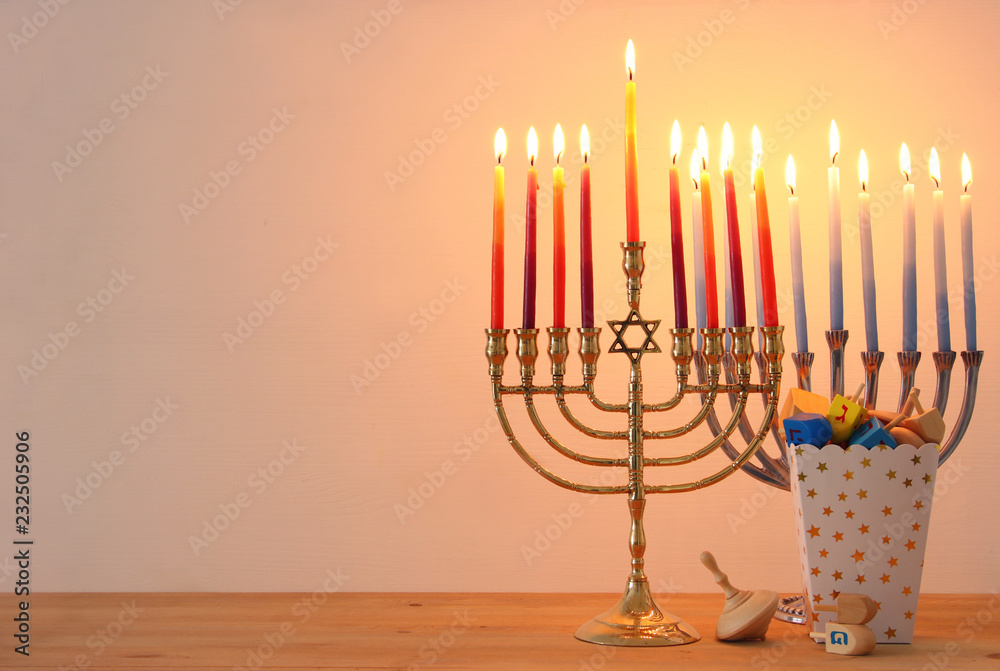 Image of jewish holiday Hanukkah background with traditional spinnig top, menorah (traditional candelabra) and burning candles. Image of jewish holiday Hanukkah background with traditional spinnig top, menorah (traditional candelabra) and burning candles.