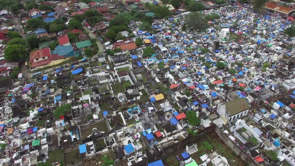 All Saint's Day scene of Messy city public cemetery lie dead residents who cannot afford decent memorial lot and services. Drone Aerial Shot