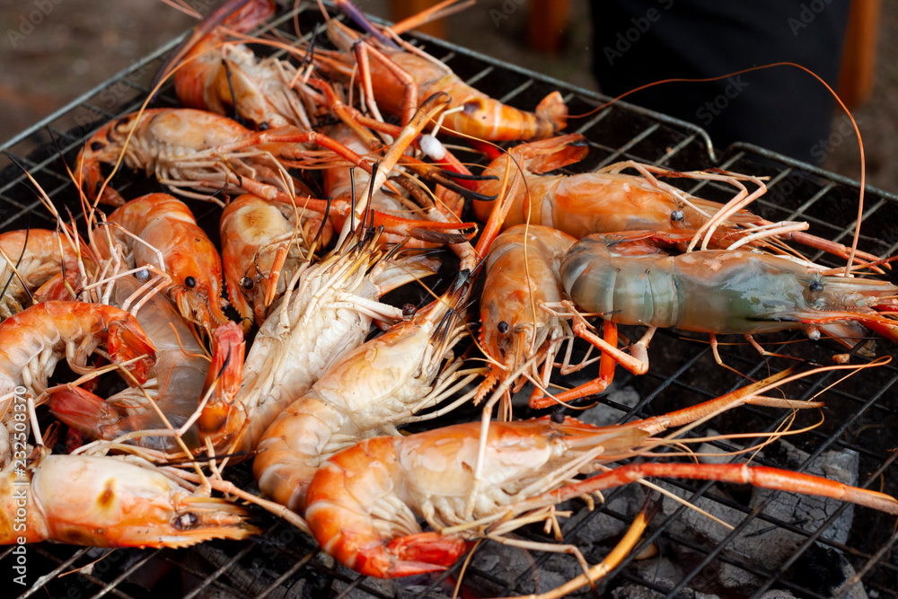 Grilled shrimp seafood on a steel grate. Grilled shrimp seafood on a steel grate.