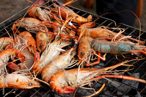 Grilled shrimp seafood on a steel grate.