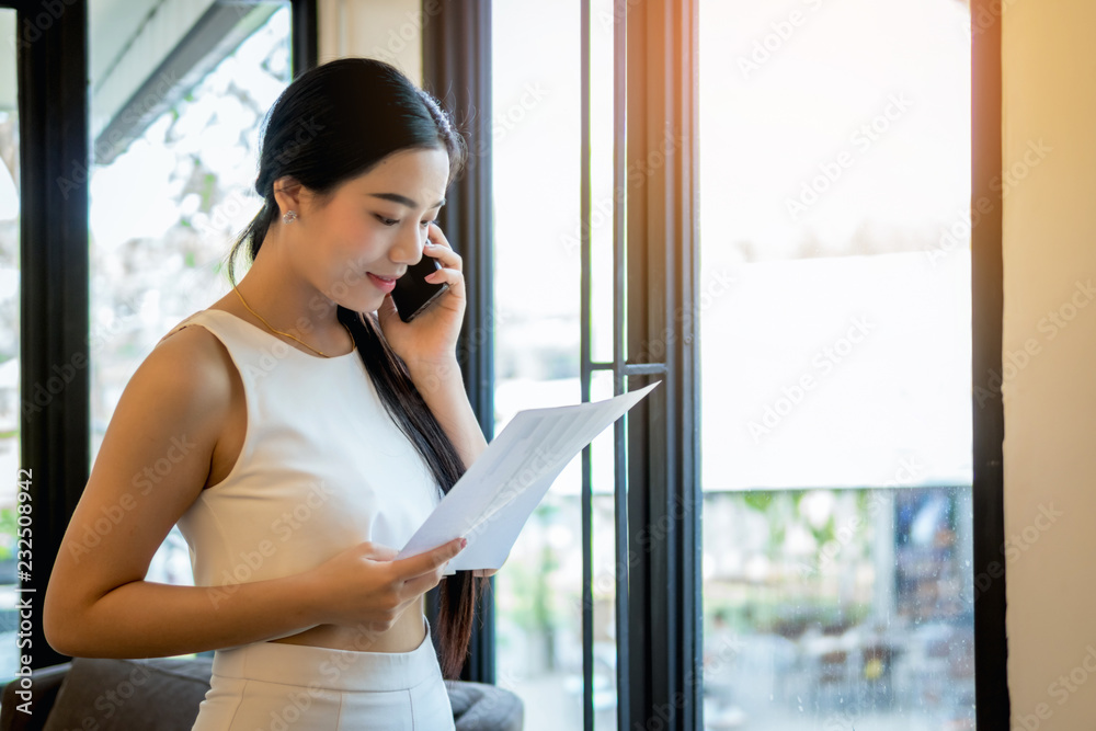 young business woman speaking with mobile phone in the office.