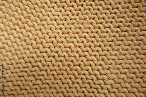 knitted yellow knitted fabric close-up natural color beige texture fabric background for decor