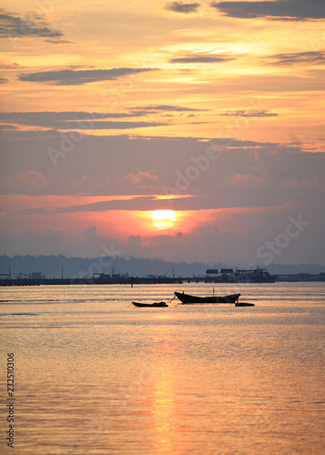 Romantic sunset view with wooden fisherman boat foreground