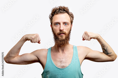 A funny mature bearded attractive guy with skinny torso, posing isolated over white studio background with raised folded hands