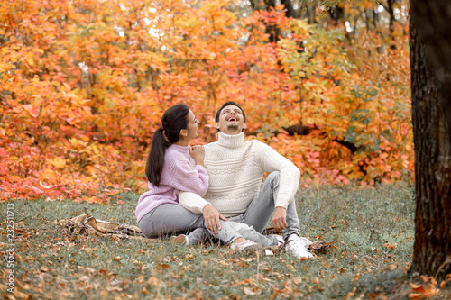 Couple in love in the autumn leaves