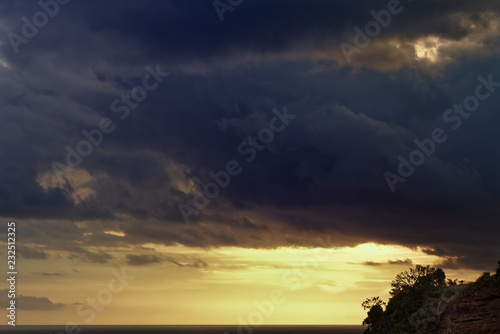 Thunderstorm clouds over the sea at sunset