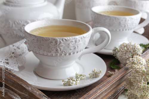 Yarrow tea in white cups with fresh yarrow twigs
