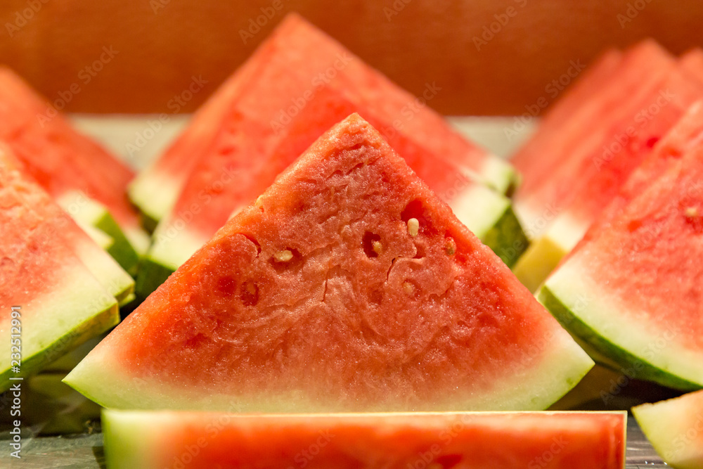 Slices of watermelon on a breakfast buffet, with a shallow depth of field