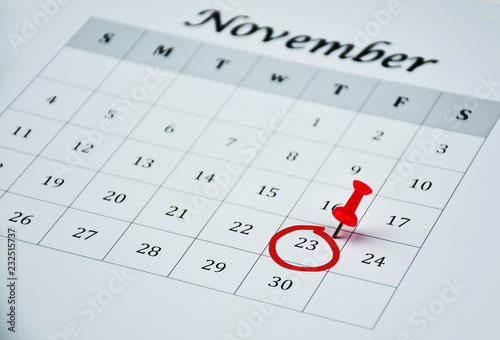 Black Friday concept which is on Friday 23rd of November in 2018, an informal name for the day following Thanksgiving Day in the United States, red pin and red circle on the white calendar dated 23rd
