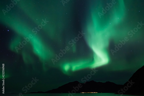 Amazing Aurora Borealis in North Norway  Grotfjord   mountains and sea in the background