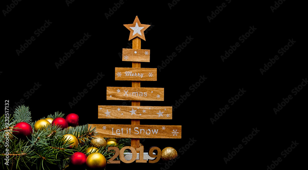 Marry Christmas and happy New Year 2019 layout. The black background is decorated with numbers 2019, Christmas toys and a Christmas tree. Marry Christmas and happy New Year 2019 layout. The black background is decorated with numbers 2019, Christmas toys and a Christmas tree.
