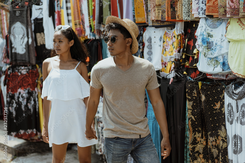 asian couple tourist walking in souvenir market shop