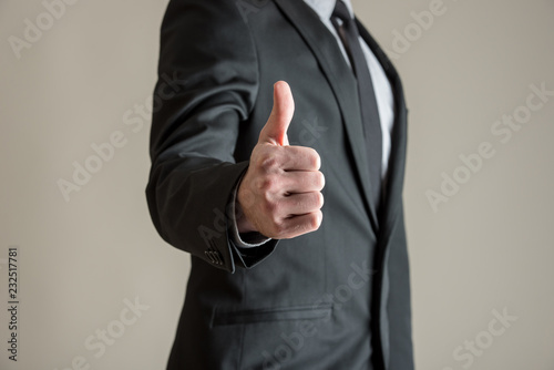 Front view of businessman showing a thumbs up sign