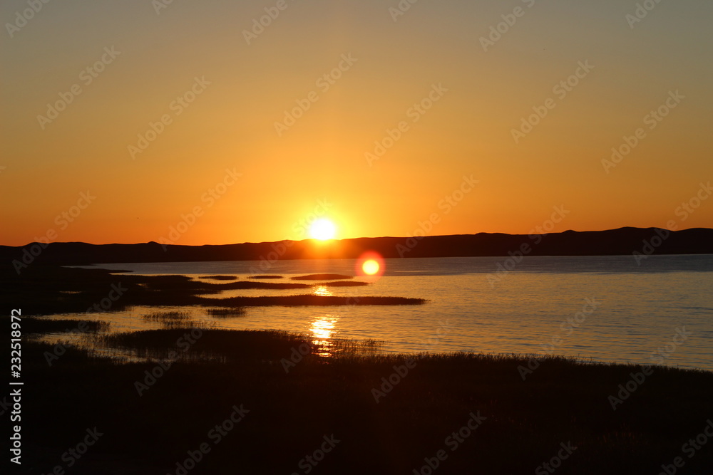 Summer golden sunrise on the lake