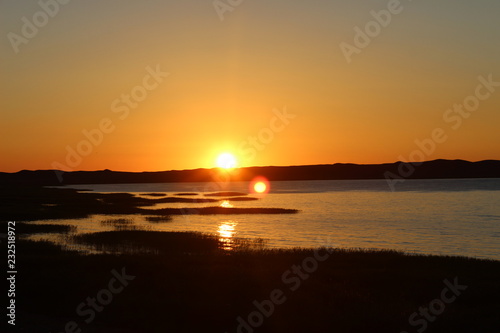 Summer golden sunrise on the lake