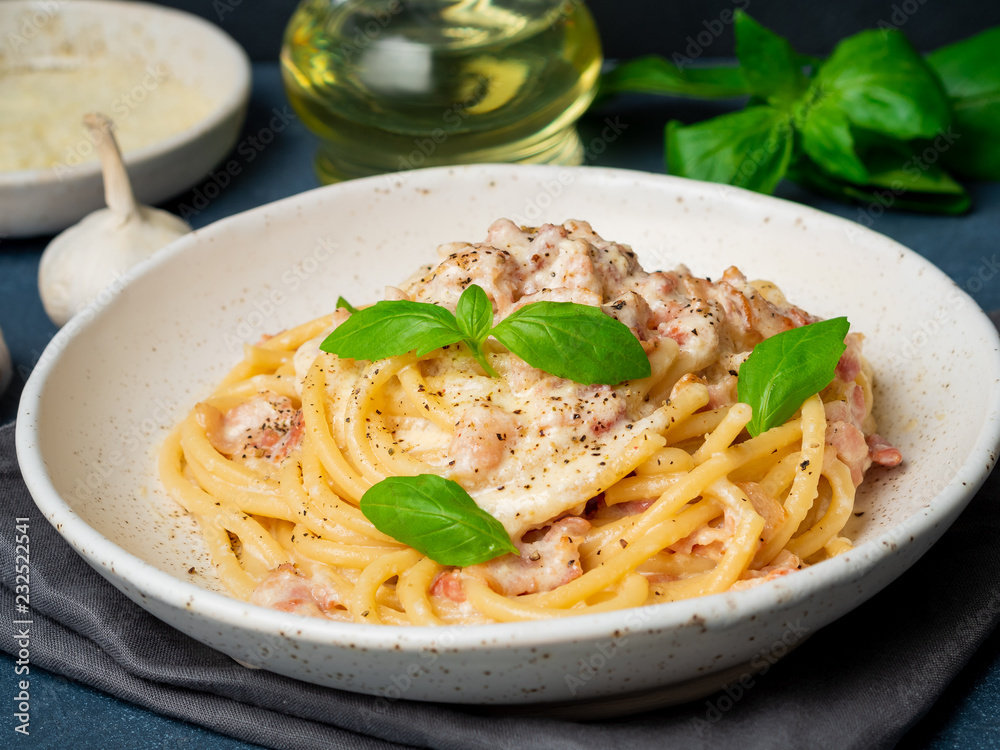 Carbonara pasta, spaghetti with pancetta, egg, parmesan cheese, cream sauce. Traditional italian cuisine. Side view, close up Carbonara pasta, spaghetti with pancetta, egg, parmesan cheese, cream sauce. Traditional italian cuisine. Side view, close up