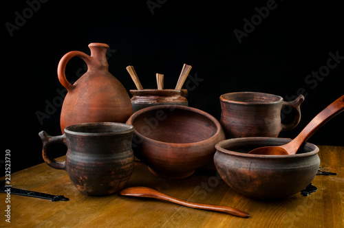 Set of antique pottery on wooden background