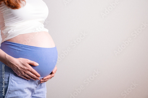 Young pregnant woman with orthopedic support belt