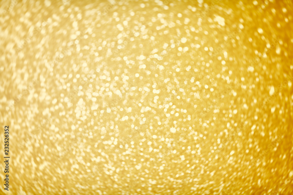 Golden sparkle glitters with bokeh effect and selectieve focus. Festive background with bright gold lights. Christmas mood concept. Copy space, close up, texture, top view. Golden sparkle glitters with bokeh effect and selectieve focus. Festive background with bright gold lights. Christmas mood concept. Copy space, close up, texture, top view.