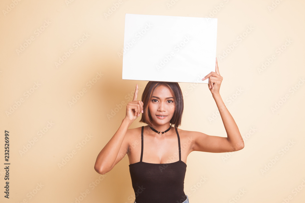 Young Asian woman point to blank sign. Young Asian woman point to blank sign.