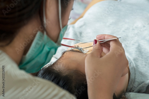 Beautician gives lashes treatment to her client