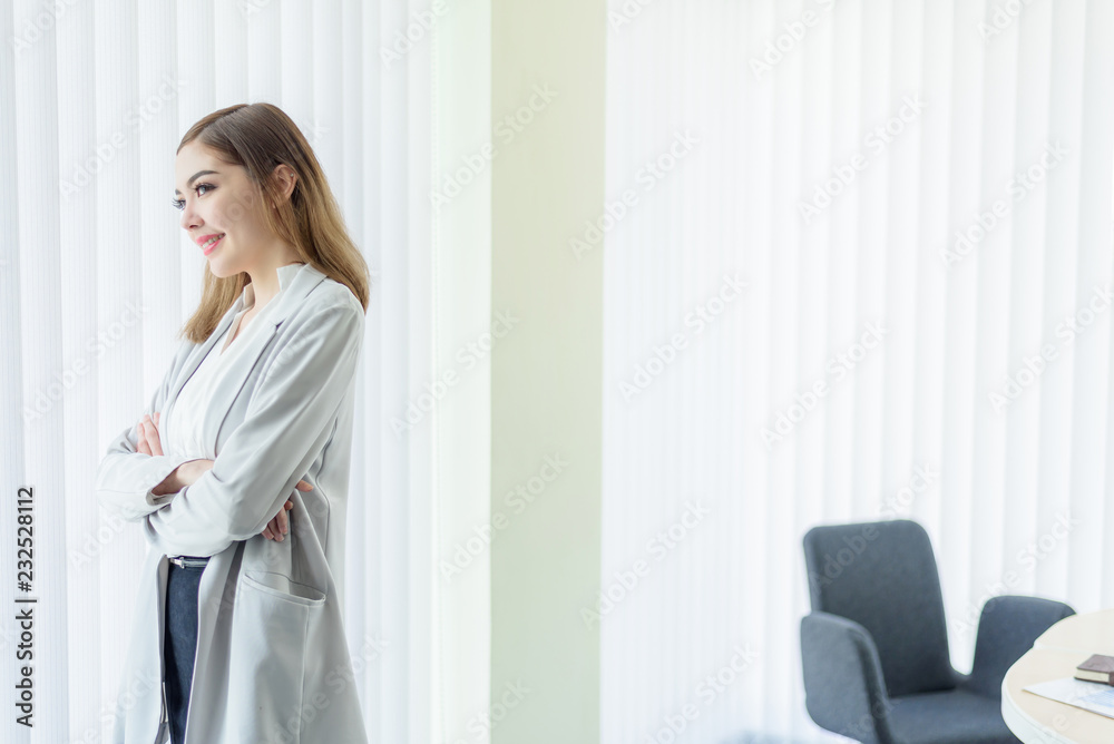 Young Beautiful Business Woman in White Modern Office Room with Young Beautiful Business Woman in White Modern Office Room with