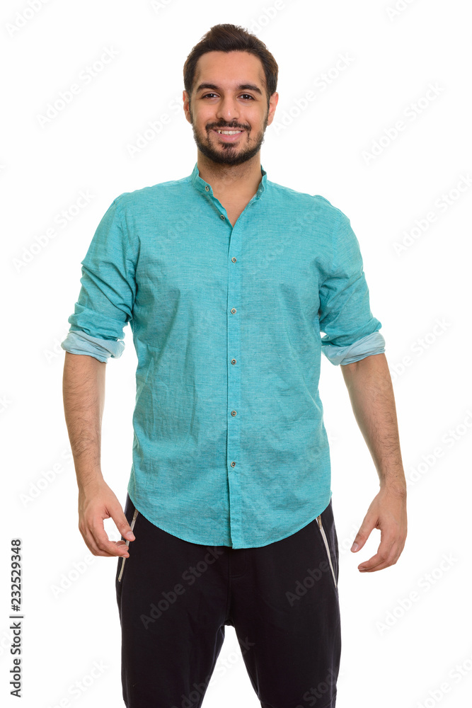 Young happy Indian man smiling and looking at camera Young happy Indian man smiling and looking at camera