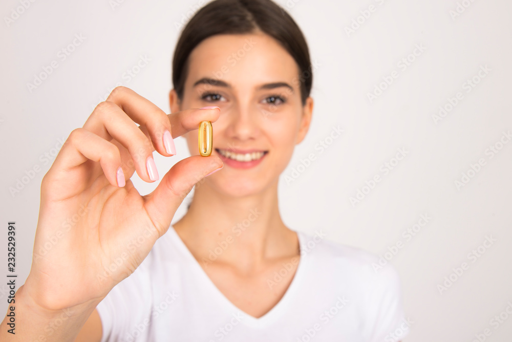 beautiful girl holding pill or capsule close up isolated beautiful girl holding pill or capsule close up isolated