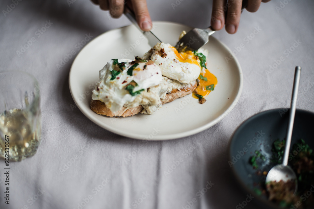 Eating poached eggs from across a table Eating poached eggs from across a table