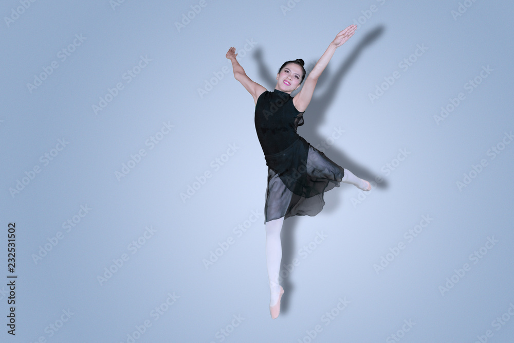 Pretty ballerina performing dances on studio Pretty ballerina performing dances on studio