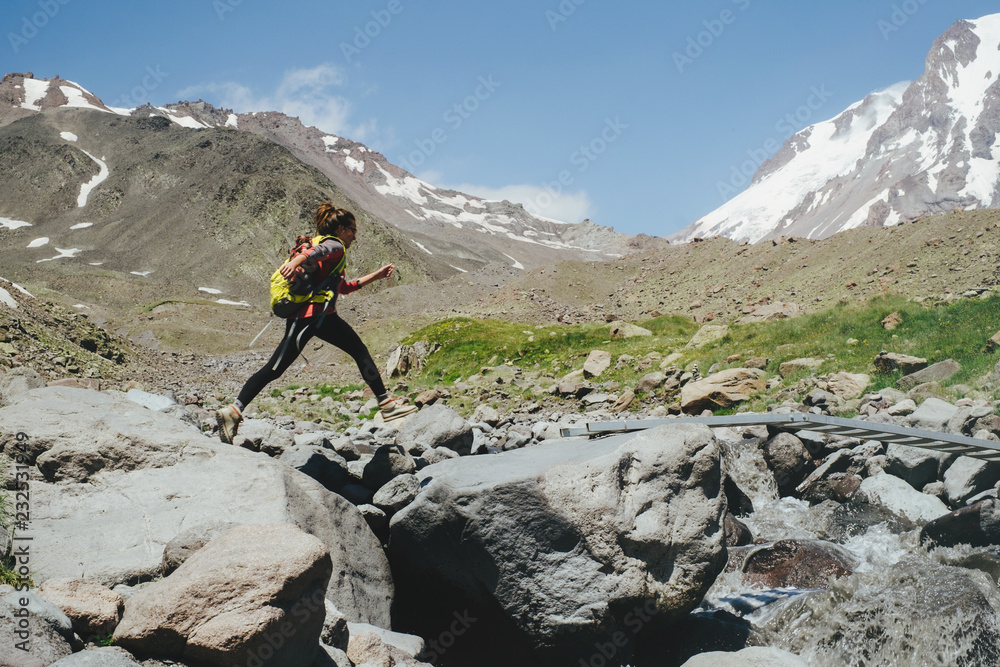 Young woman hiking in the mountains Young woman hiking in the mountains