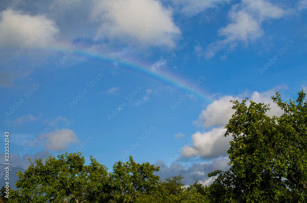 Summer. Rainbow in the blue sky