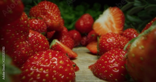 Vai a pagina |123456Avanti super macro slide shot of strowberries on a wooden bench, in slow motion.  photo