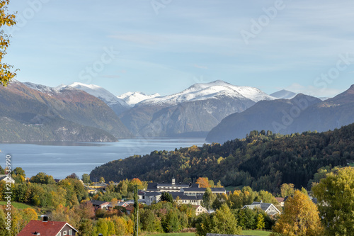 village at fjord surrounded by mountains
