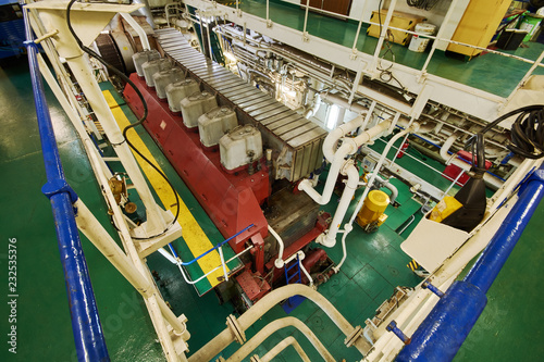 Panoramic view of main engine on a merchant ship in the engine room