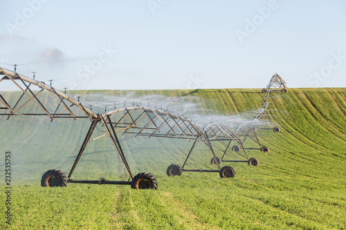 Agricultural sprinkler spraying water on a field