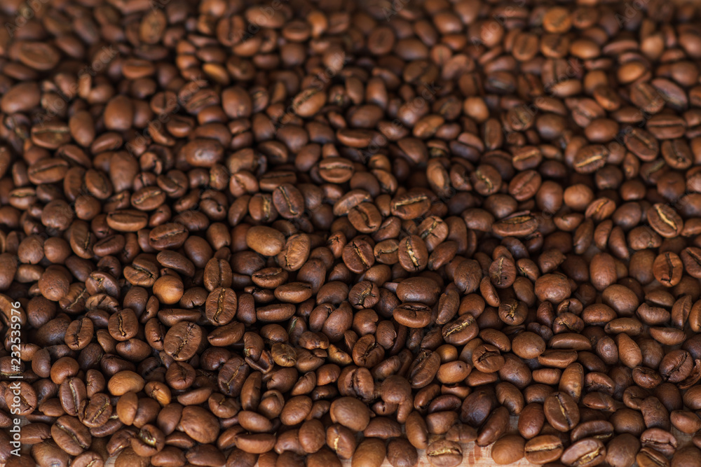 Closeup of fragrant roasted coffee beans on a wooden board. Selective focus. place for text. Closeup of fragrant roasted coffee beans on a wooden board. Selective focus. place for text.