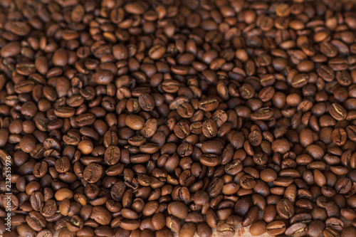 Closeup of fragrant roasted coffee beans on a wooden board. Selective focus. place for text.