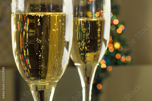 New Year's Eve. Two tables on the table. Champagne in a glass.