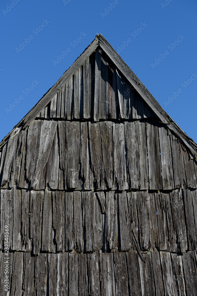 Old wooden roof against the blue sky Old wooden roof against the blue sky