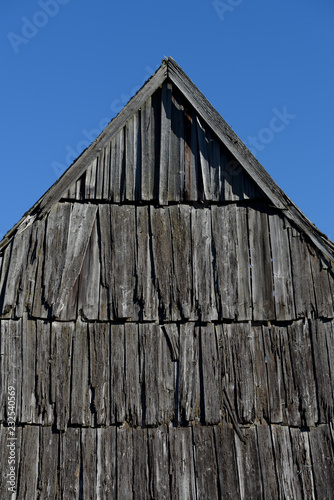 Old wooden roof against the blue sky