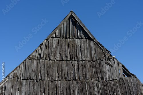 Old wooden roof against the blue sky