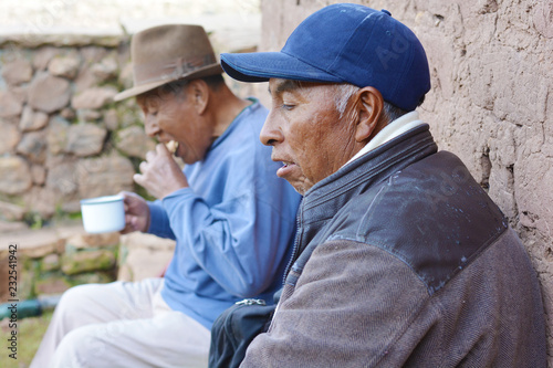 Native american old men eating outside.