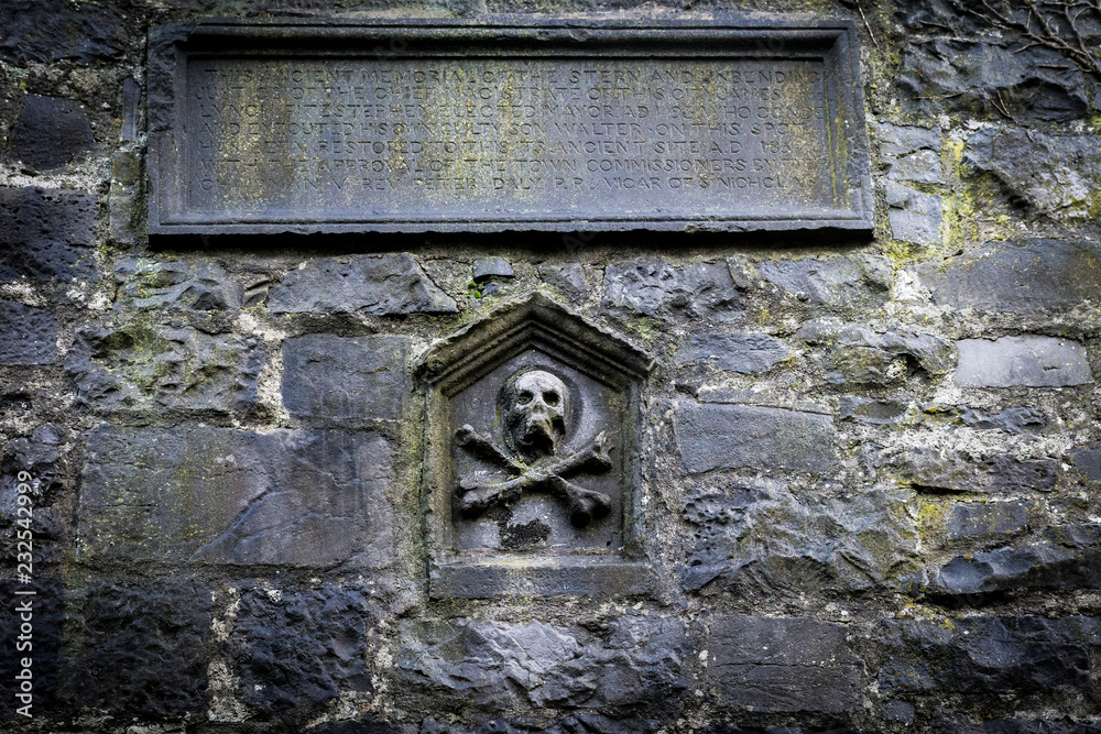 skull and cross bones in stone